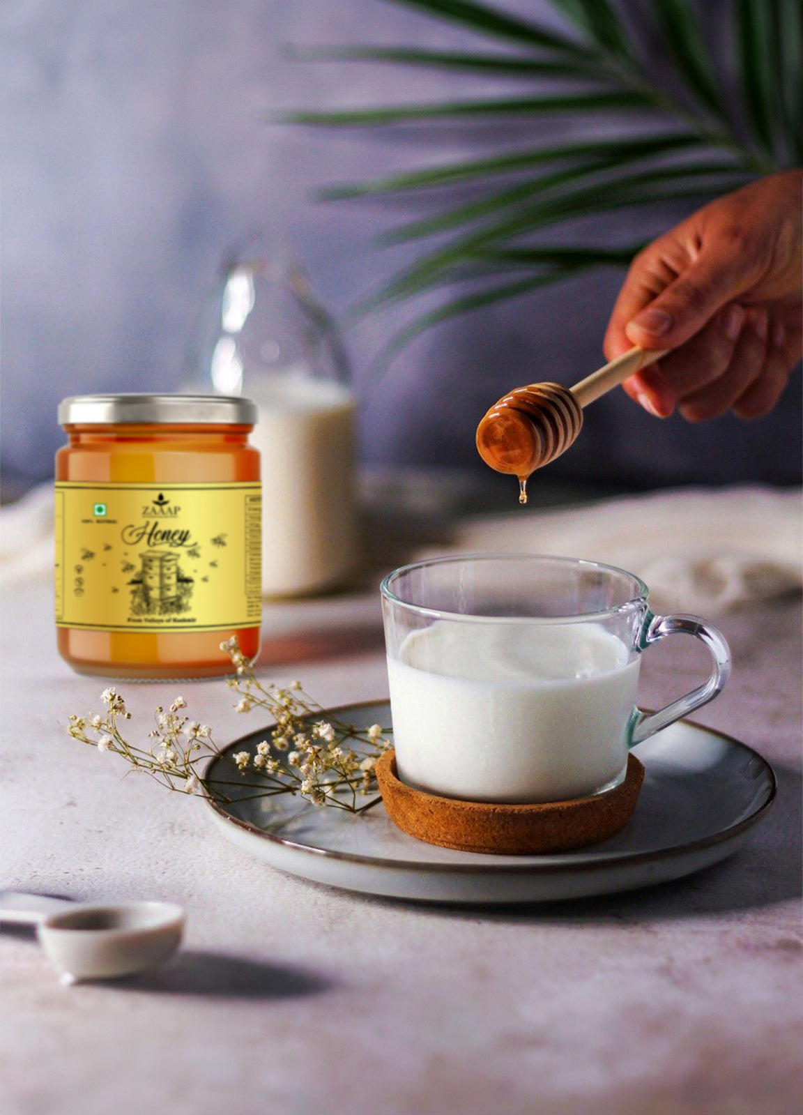 Hand drizzling pure organic honey from a wooden dipper into a glass of warm milk, with a jar of natural raw honey nearby, promoting a healthy sweetener alternative packed with natural goodness.
